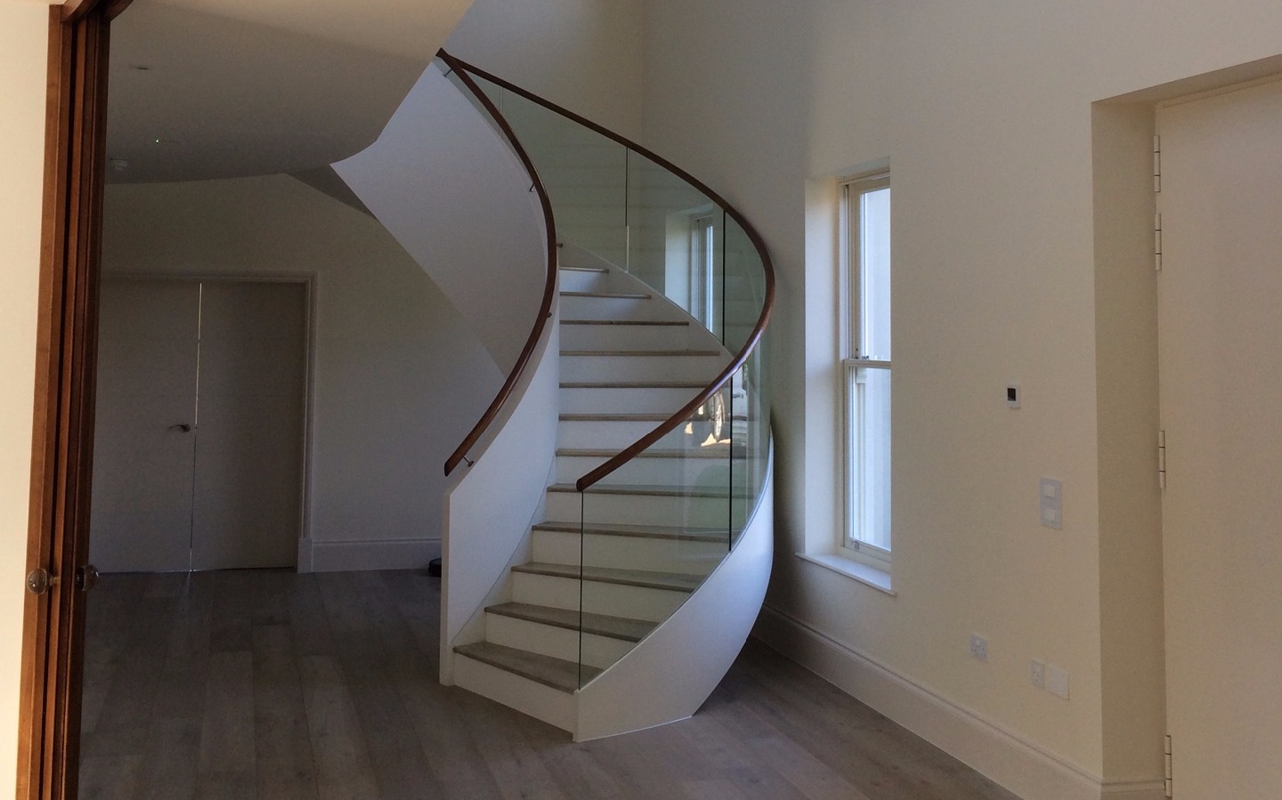 Kallisto curved stair finished with glass balustrade
