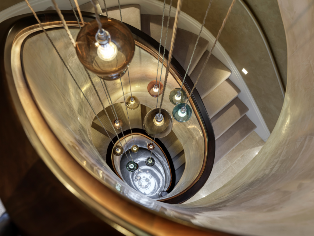 Encapsulating hanging lights with a bespoke curved stair