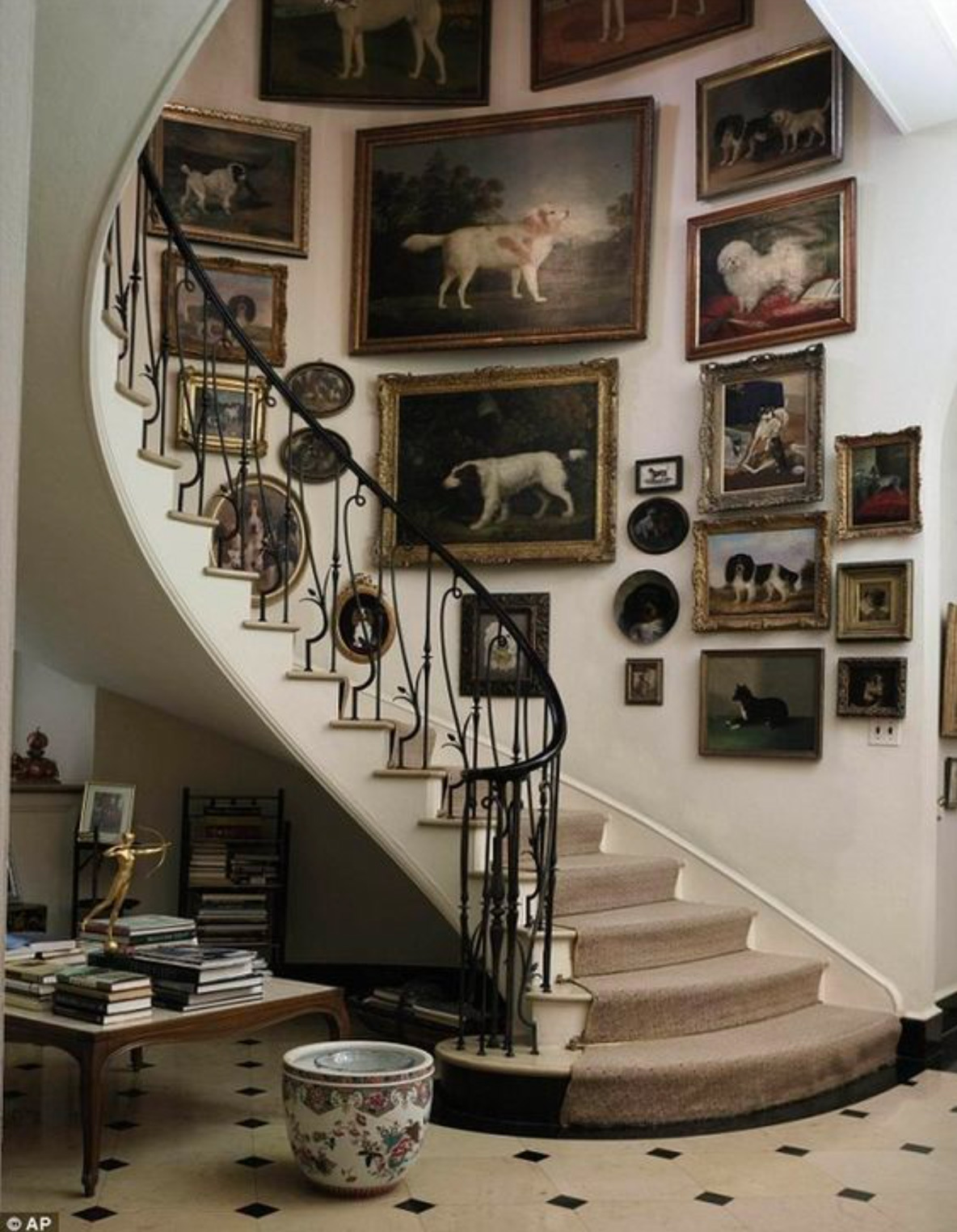pictures hanging around curved staircase