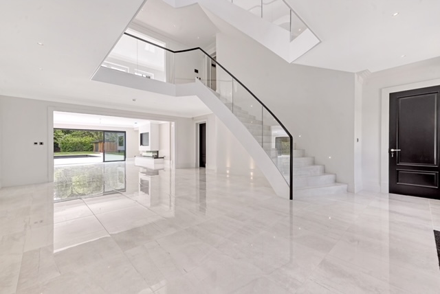 Bi-folding doors with with marble floors and luxury staircase in new build property