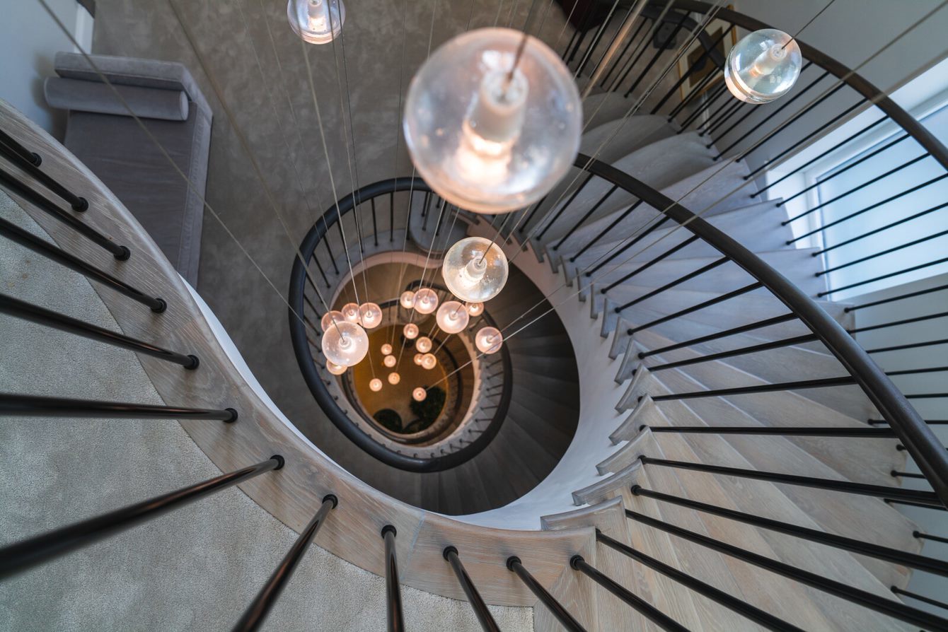Aerial view showing contemporary chandelier of curved luxury staircase
